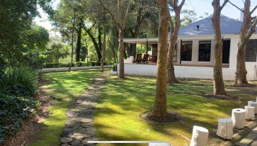 a house with a stone path in front of a yard at Silvermist Wine Estate in Cape Town
