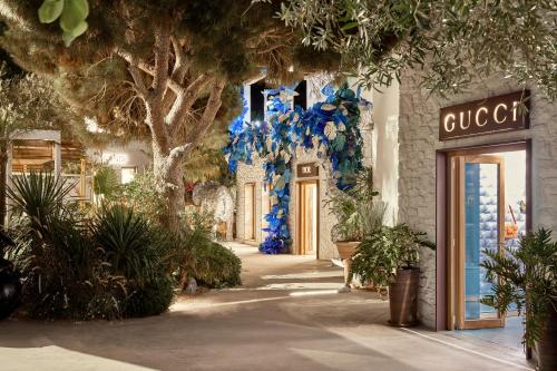 a store front with blue flowers and plants at Nammos Hotel Mykonos in Psarou