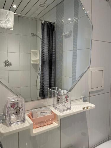 a bathroom with a sink and a mirror at Green Villa in Pärnu