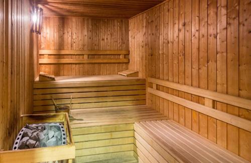 a sauna with wooden walls and wooden flooring at Leonardo Hotel Fuengirola Costa del Sol in Fuengirola