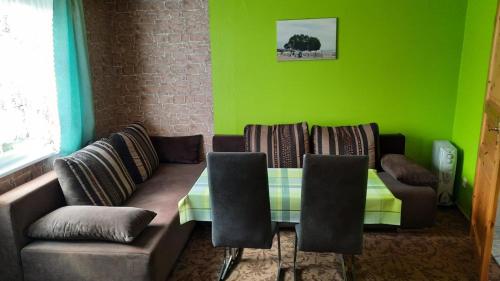 a living room with a couch and a table and chairs at Ferienhaus Baake in Mönkebude