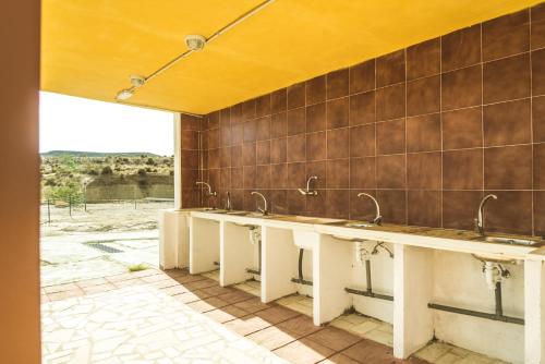 a row of sinks in a bathroom with a window at Camping Fort Bravo in Tabernas