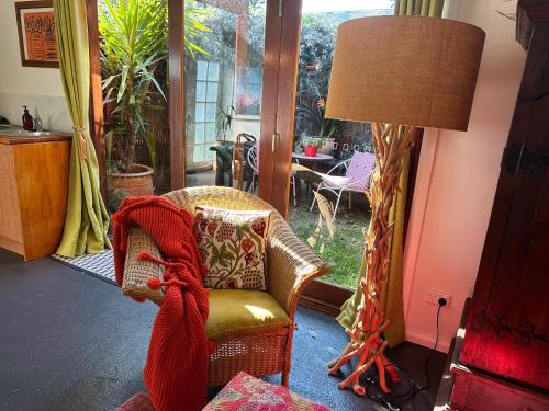 a living room with a chair and a lamp at The Red Barn right in the heart of historic Berry in Berry