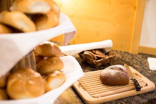 a bunch of bread on a counter with a tray of pastries at AlpinSpa zur Post Apartment - Bergbahn im Sommer 2025 inklusive in Bad Gastein