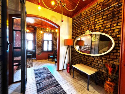 a living room with a brick wall and a mirror at Dream House in Istanbul