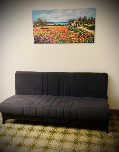 a couch in a room with a painting on the wall at Dolce Casa in Casalabate