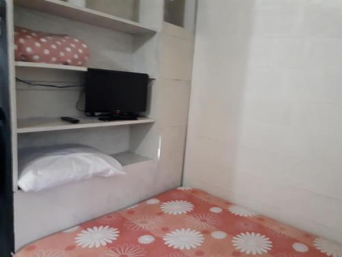 Una cama o camas en una habitación de Mini casa (kit net)