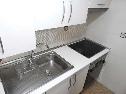 a small kitchen with a sink and a counter at Aguadulce Primera Línea - A/C in Aguadulce