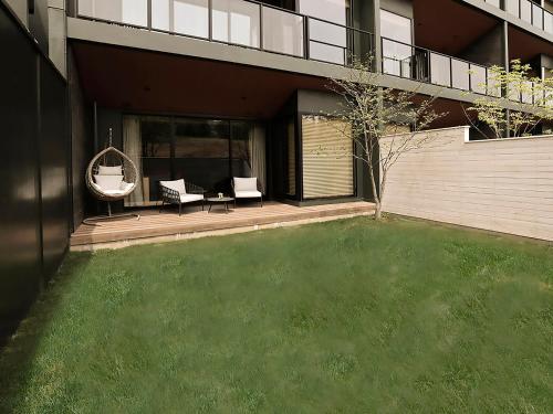 a house with a yard with a swing and a lawn at ANA InterContinental Appi Kogen Resort by IHG in Hachimantai