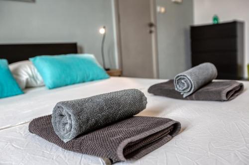 two towels sitting on top of a bed at 49/3 Seafront Duplex Penthouse in Valletta in Valletta