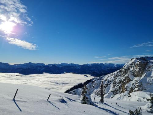 a view of a snowy mountain with the sun in the sky at Happy Nest in Göstling an der Ybbs