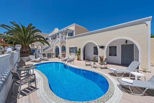 a villa with a swimming pool and patio furniture at Phoenix in Fira
