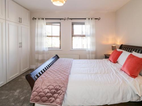1 dormitorio con 1 cama grande con almohadas rojas en Owen Tucker View House, en Ardara