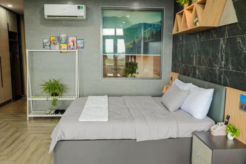 a bedroom with a large bed in a room at Cherry Hotel Bến Lức in Bến Lức