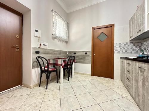 a kitchen with a table and chairs in a room at Moonlight in Castellammare di Stabia