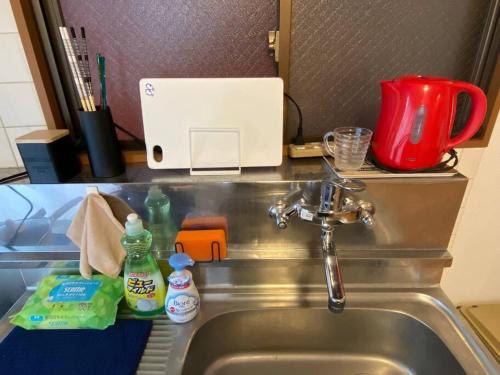 a kitchen counter with a sink and a red appliance at 1min walk to sta, drct bus to HND! Easy access! 01 in Tokyo