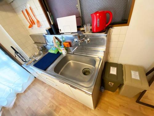 a small kitchen with a sink in a room at 1min walk to sta, drct bus to HND! Easy access! 01 in Tokyo