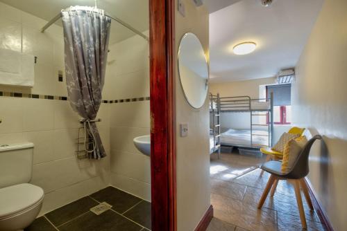 a bathroom with a toilet and a sink and a bed at Barn in Sedbergh