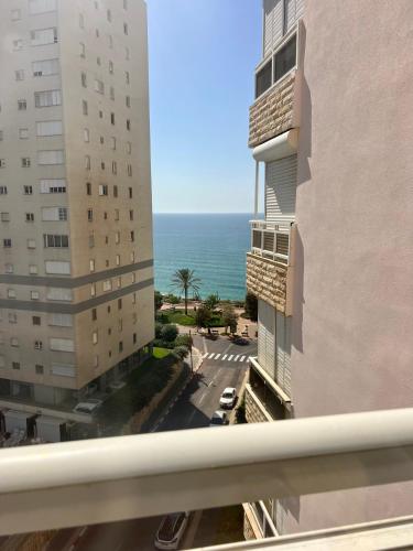 a view of the ocean from the balcony of a building at The Symphony of the Breeze in Netanya