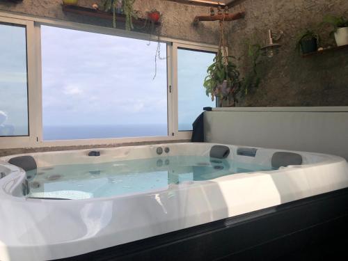 a bath tub with a view of the ocean at Paraiso da Pedreira in Nordeste