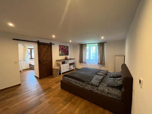 a bedroom with a bed and a dresser in it at Šumavský grunt in Podmokly