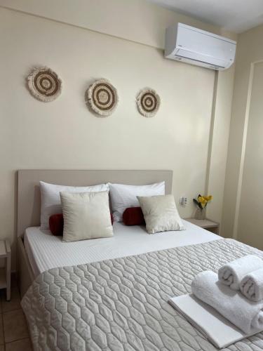 a bedroom with a large bed with towels on it at Stergios_Apartments 02 in Kozani