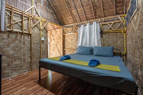 Łóżko w niewielkim pokoju ze ścianą w obiekcie Breeze Bungalows w mieście Ko Lanta