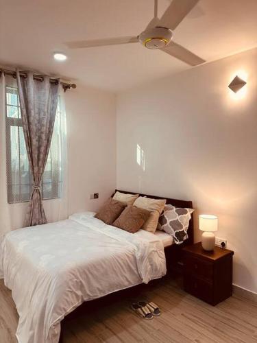 Un dormitorio con una cama grande y una ventana en The Cozier, the Better at Oysterbay, en Dar es Salaam