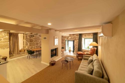 a large living room with a couch and a table at Casa Poesia - Santar in Santar