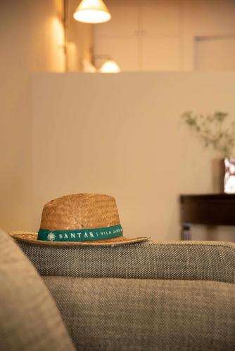 a hat sitting on the back of a couch at Casa Poesia - Santar in Santar