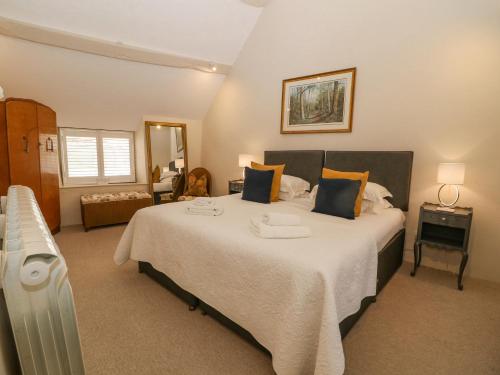a bedroom with a large bed with a radiator at The Apartment Stow-on-the-Wold in Stow on the Wold