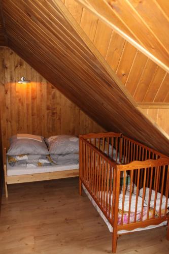 a bedroom with a bed in a attic at Domek Wypoczynkowy OSTOJA in Baligród