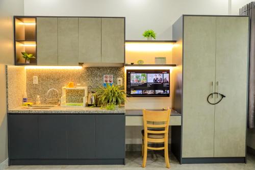 a kitchen with gray cabinets and a counter top at Cherry Hotel Bến Lức in Bến Lức
