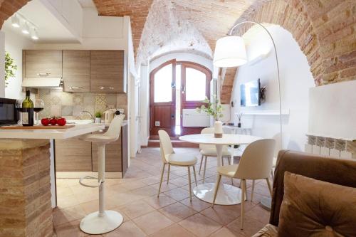 a kitchen and dining room with a table and chairs at Medieval flat with whirlpool bath in Perugia