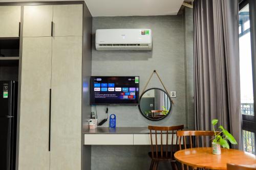a room with a table and a mirror at Cherry Hotel Bến Lức in Bến Lức