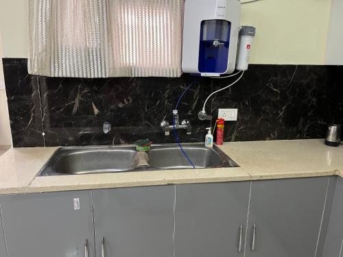 a kitchen sink with a soap dispenser above it at Hare Krishna’s in Kharar