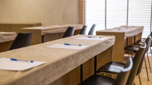 a classroom with rows of tables and chairs with pens on them at Seth Port Ciutadella in Ciutadella