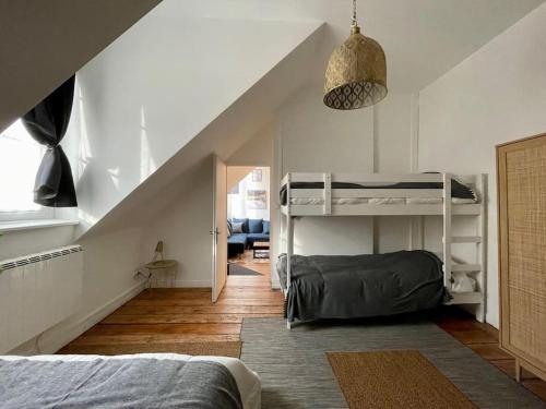 a bedroom with two bunk beds and a staircase at Belle Isle - Grand appart - 6 Places - T3 - 72m2 in Metz