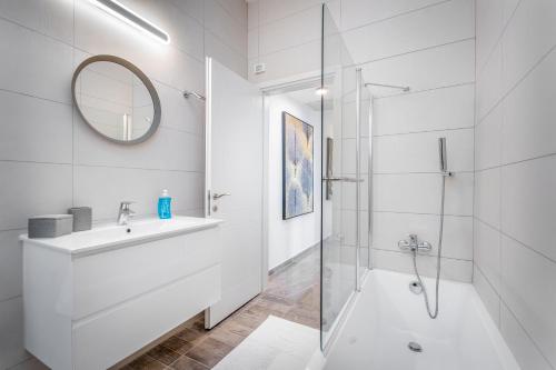 a white bathroom with a sink and a shower at Luxury 2BR with Nice View - Next King David Hotel in Jerusalem