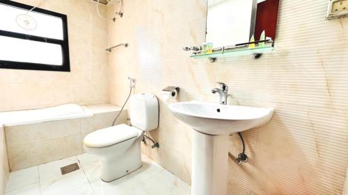 a bathroom with a toilet and a sink at Sharjah Plaza Hotel in Sharjah