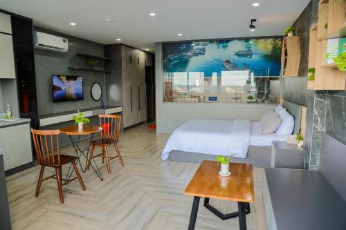 a hotel room with a bed and a table and chairs at Cherry Hotel Bến Lức in Bến Lức