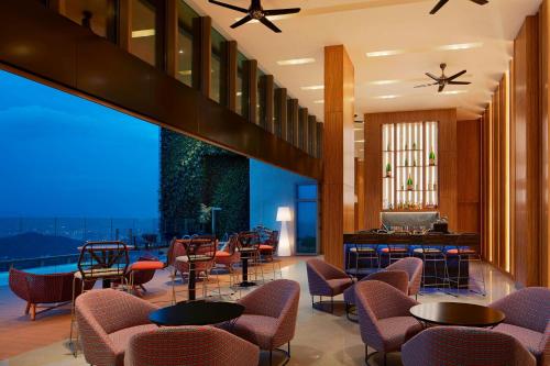 a hotel lobby with chairs and tables and a view at Sheraton Petaling Jaya Hotel in Petaling Jaya