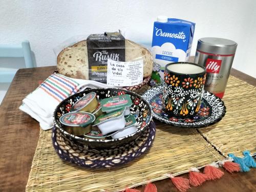 a table topped with a basket of food and bread at La casa de tío Vidal in Pedro Bernardo