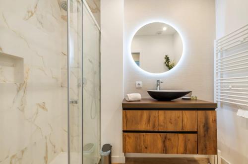 a bathroom with a sink and a mirror at Monte Estoril Seabreeze in Estoril