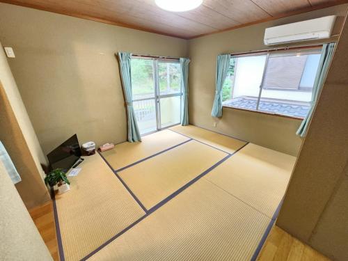 an empty room with a room with two windows at Ohama House in Sumoto