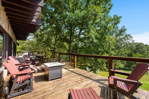 a deck with chairs and a grill on a house at Ozark Outdoor Legacy in Ridgedale