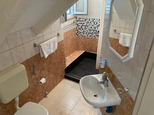 a small bathroom with a sink and a shower at guesthouse Libertas 3 in Dubrovnik
