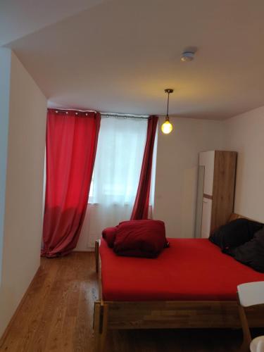 a bedroom with a red bed and a window at Private Parking-Top Retreat Residence in Vienna - Long Stays available in Vienna