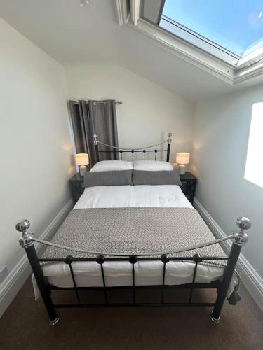 a bedroom with a bed in a room with a window at Beautiful 4BR Home near Chester Racecourse in Chester