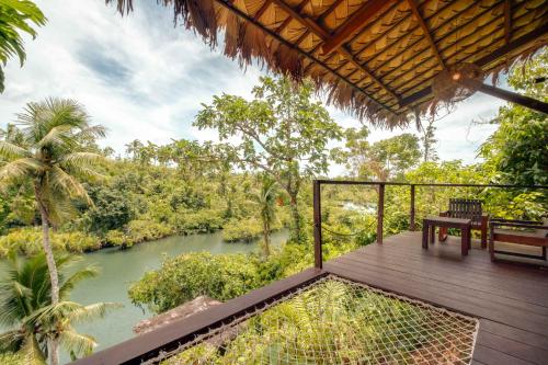 a deck with a view of a river at The River Hideaway in General Luna